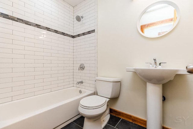 2625 W Cullerton St, Chicago, IL 60608 - bathroom with shower / bathing tub combination, tile patterned flooring, toilet, and baseboards
