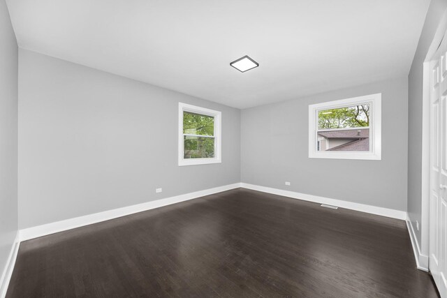 16560 Woodlawn W Ave, South Holland, IL 60473 - unfurnished bedroom featuring multiple windows, dark wood-style floors, and baseboards