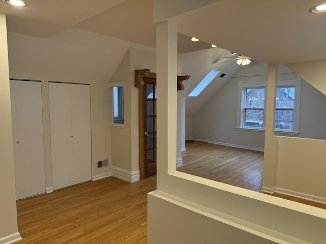 2446 W Thomas St, Chicago, IL 60622 - bonus room with ceiling fan, lofted ceiling with skylight, wood finished floors, and visible vents