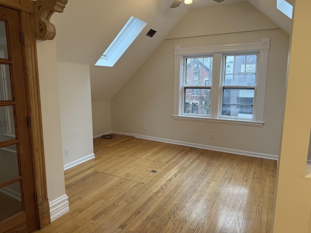 2446 W Thomas St, Chicago, IL 60622 - additional living space featuring vaulted ceiling with skylight, light wood-style flooring, baseboards, and a ceiling fan