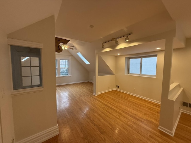 2446 W Thomas St, Chicago, IL 60622 - additional living space with baseboards, wood finished floors, and lofted ceiling with skylight