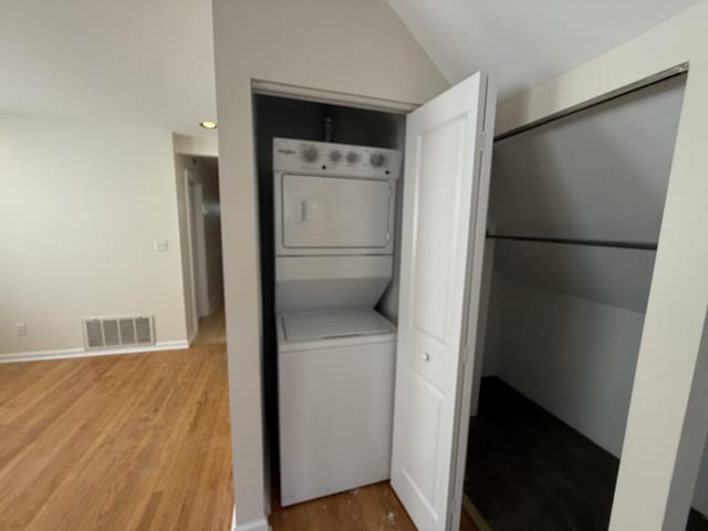 2446 W Thomas St, Chicago, IL 60622 - laundry room with visible vents, stacked washer / drying machine, laundry area, and wood finished floors