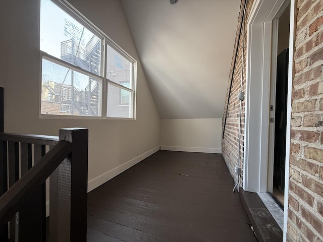 2446 W Thomas St, Chicago, IL 60622 - bonus room featuring dark wood finished floors, baseboards, brick wall, and lofted ceiling