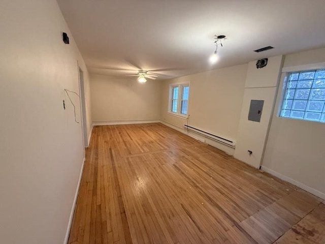 2446 W Thomas St, Chicago, IL 60622 - unfurnished living room featuring a baseboard heating unit, light wood-style flooring, baseboards, visible vents, and ceiling fan