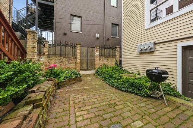 2446 W Thomas St, Chicago, IL 60622 - view of patio featuring a gate, fence, stairs, and grilling area
