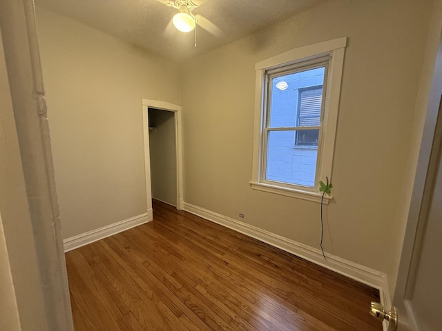 2446 W Thomas St, Chicago, IL 60622 - unfurnished bedroom with a closet, baseboards, and dark wood finished floors