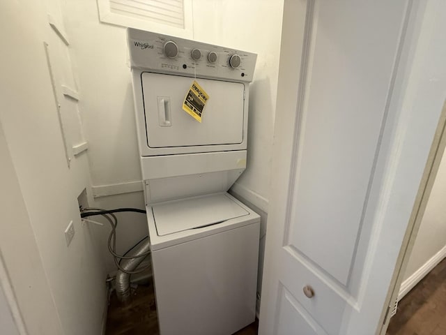2446 W Thomas St, Chicago, IL 60622 - clothes washing area featuring baseboards, stacked washing maching and dryer, dark wood-style floors, and laundry area