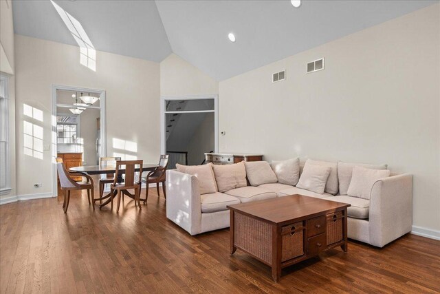 572 Vine Ave, Highland Park, IL 60035 - living room with dark wood-type flooring, baseboards, visible vents, and high vaulted ceiling
