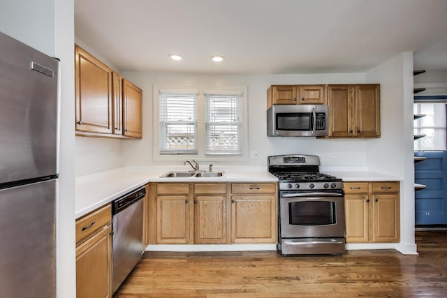 9633 Karlov Ave, Skokie, IL 60076 - kitchen featuring stainless steel appliances, light countertops, wood finished floors, and recessed lighting