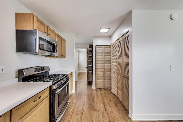 9633 Karlov Ave, Skokie, IL 60076 - kitchen featuring stainless steel appliances, light wood-style flooring, and light countertops