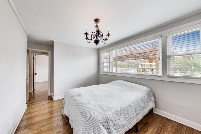 9633 Karlov Ave, Skokie, IL 60076 - bedroom featuring a chandelier and wood finished floors