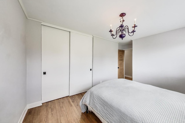 9633 Karlov Ave, Skokie, IL 60076 - bedroom featuring a chandelier, a closet, and light wood finished floors