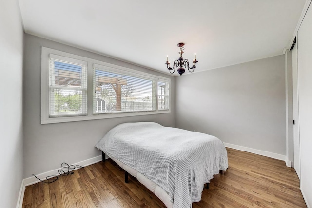 9633 Karlov Ave, Skokie, IL 60076 - bedroom featuring a chandelier, wood finished floors, and a closet