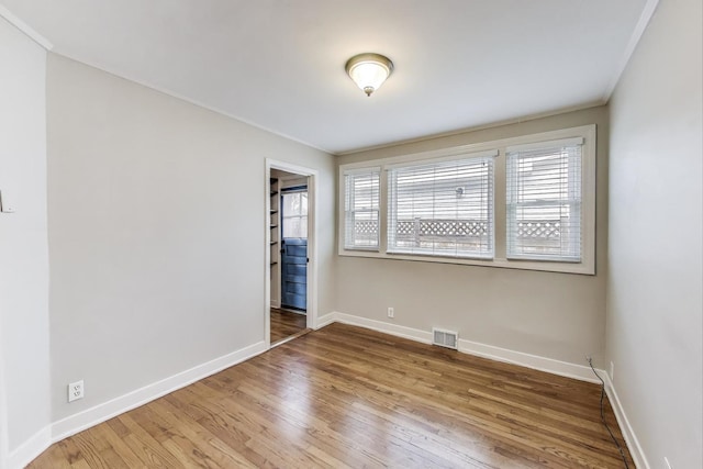 9633 Karlov Ave, Skokie, IL 60076 - unfurnished room with wood finished floors and crown molding