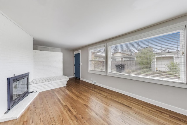 9633 Karlov Ave, Skokie, IL 60076 - unfurnished living room featuring wood finished floors and a fireplace