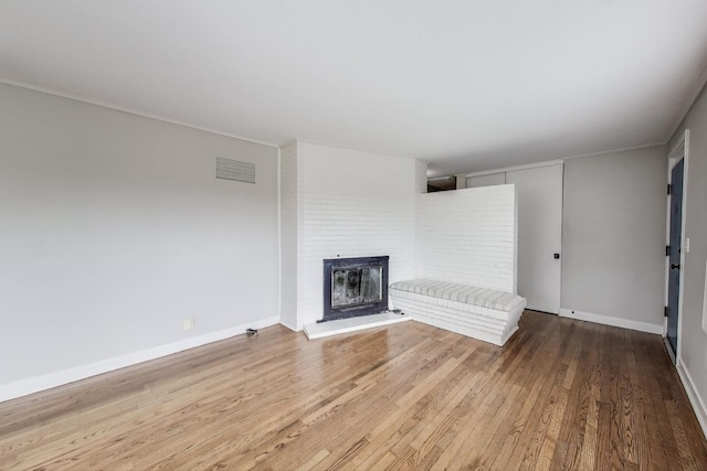 9633 Karlov Ave, Skokie, IL 60076 - unfurnished living room with wood finished floors and a brick fireplace