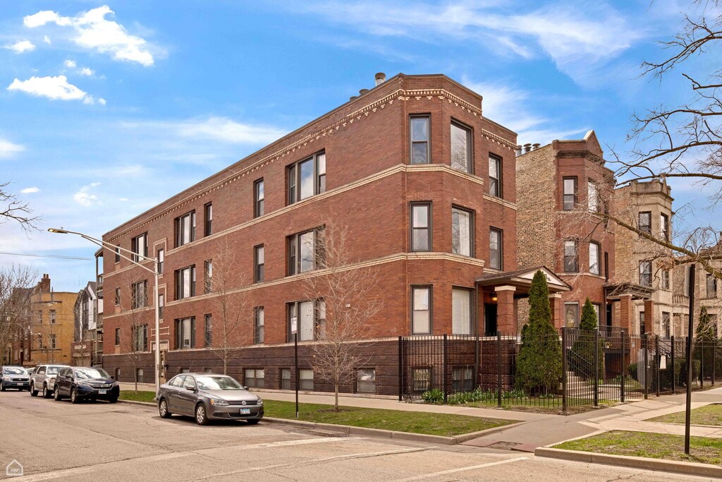 2148 N Sawyer Ave Unit 302, Chicago, IL 60647 - view of building exterior featuring fence