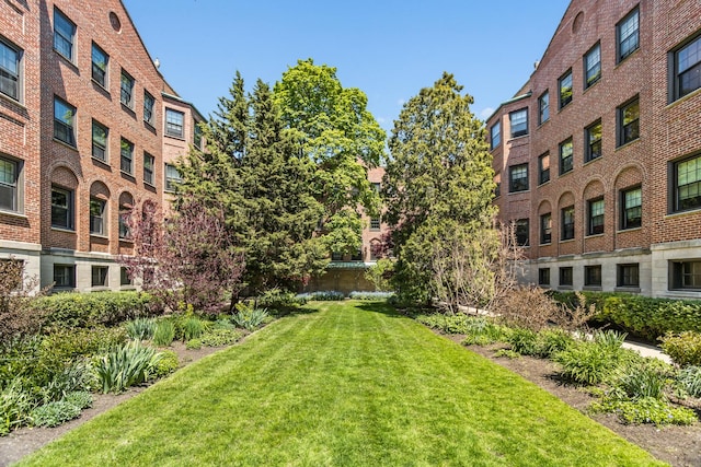 view of property's community with a lawn