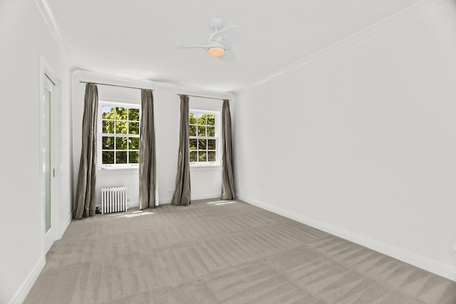 carpeted empty room with radiator, baseboards, and ornamental molding