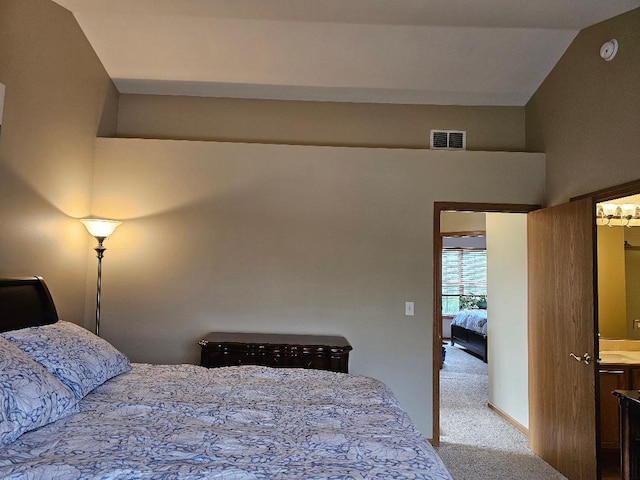 carpeted bedroom with vaulted ceiling and visible vents