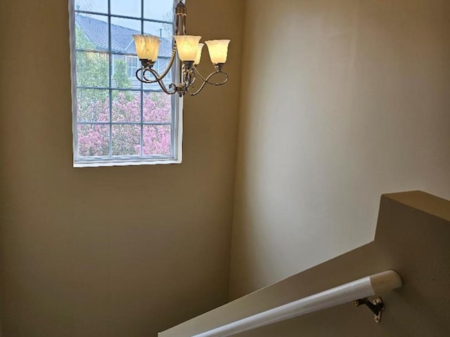 interior details featuring an inviting chandelier
