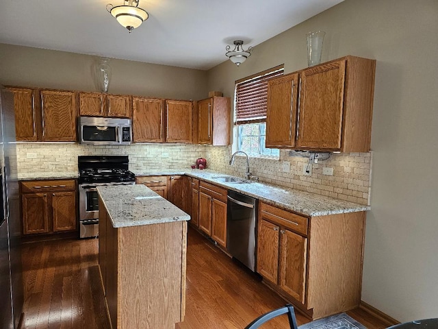 kitchen featuring a sink, dark wood-style flooring, and appliances with stainless steel finishes