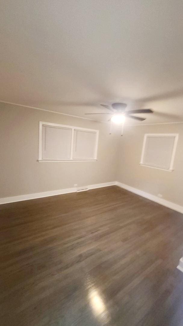 15562 Gouwens Ln, South Holland, IL 60473 - spare room with baseboards, a ceiling fan, and dark wood-type flooring