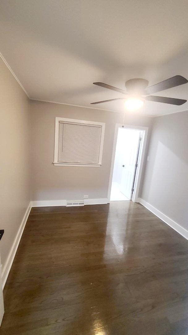 15562 Gouwens Ln, South Holland, IL 60473 - empty room featuring ceiling fan, baseboards, dark wood-style flooring, and visible vents