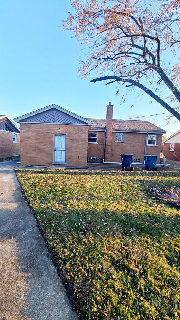 15562 Gouwens Ln, South Holland, IL 60473 - exterior space featuring a chimney and a yard