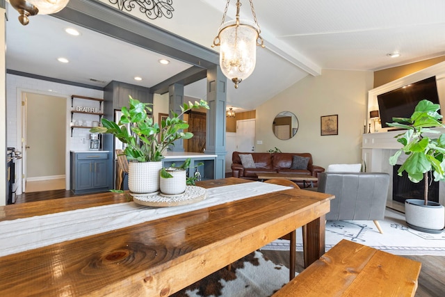 dining area with light wood finished floors, a chandelier, ornamental molding, recessed lighting, and baseboards