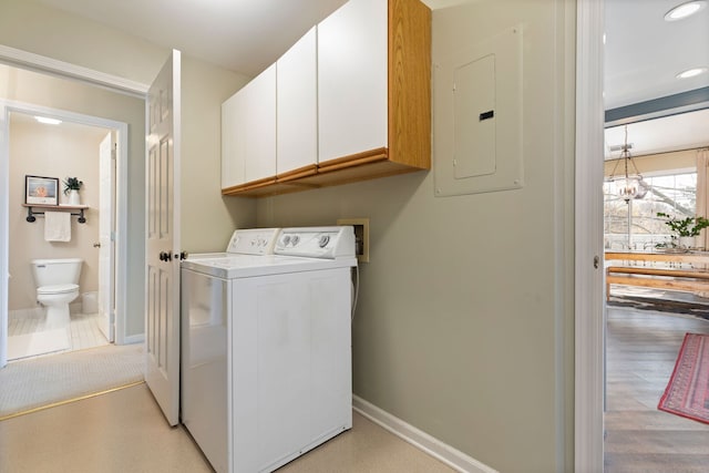 laundry area featuring electric panel, cabinet space, baseboards, washing machine and clothes dryer, and recessed lighting