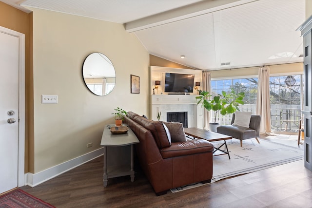 living area with a fireplace, baseboards, and dark wood finished floors