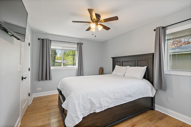 bedroom featuring light wood-style floors, baseboards, and ceiling fan