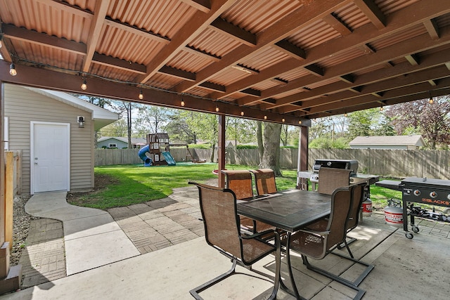 view of patio / terrace featuring outdoor dining area, a playground, and grilling area