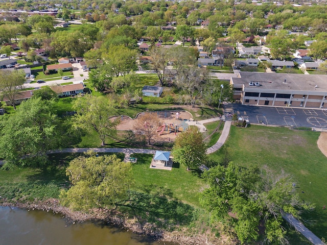 aerial view of property and surrounding area featuring nearby suburban area