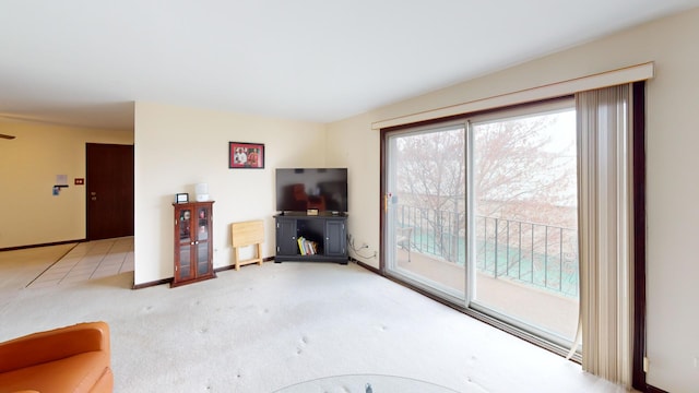 unfurnished living room featuring baseboards and carpet floors
