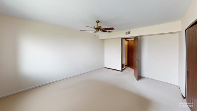 unfurnished bedroom with ceiling fan, visible vents, baseboards, and light carpet