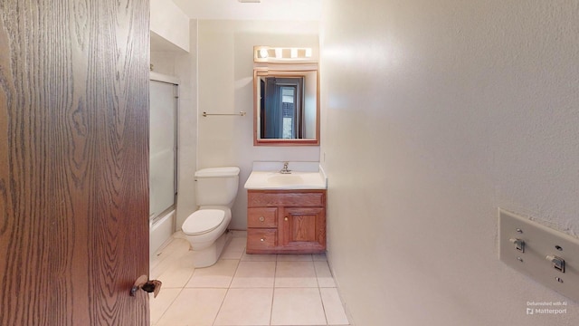 bathroom featuring vanity, toilet, and tile patterned flooring