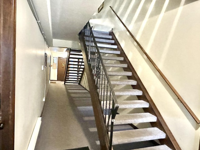 stairway featuring baseboards