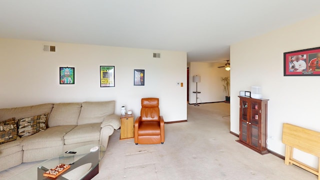 living area featuring ceiling fan, light carpet, visible vents, and baseboards