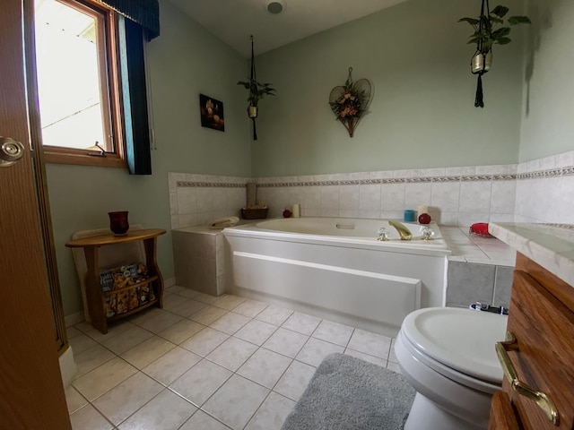 full bathroom featuring a garden tub, tile patterned flooring, and toilet