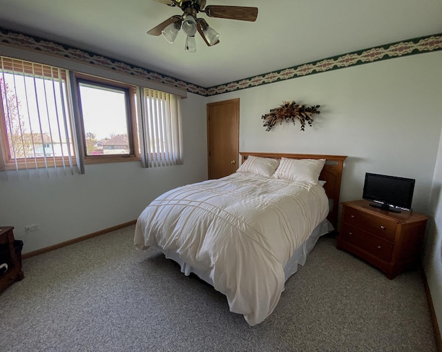 bedroom with ceiling fan, baseboards, and light colored carpet