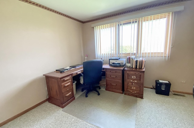 office area featuring baseboards and light colored carpet