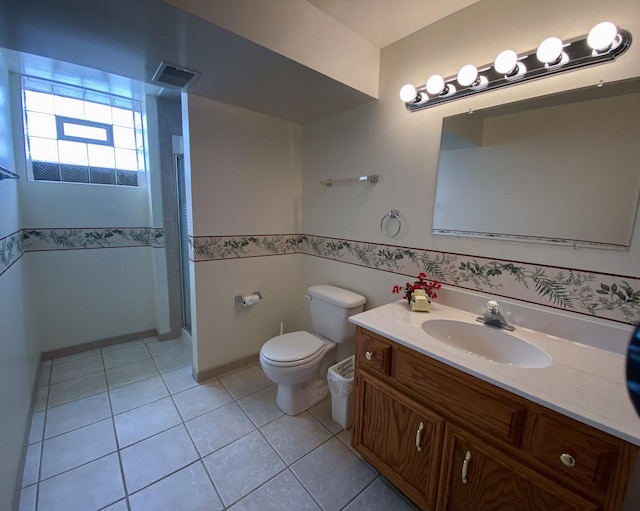 full bathroom featuring tile patterned floors, a shower with door, vanity, toilet, and visible vents
