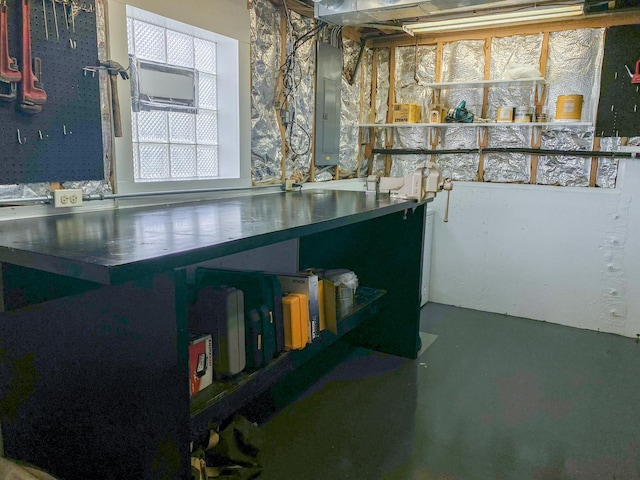interior space with electric panel and finished concrete flooring