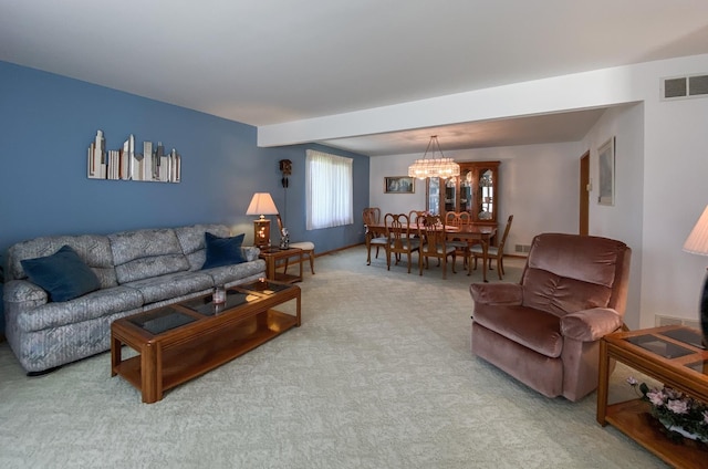 living room with an inviting chandelier, baseboards, visible vents, and carpet floors