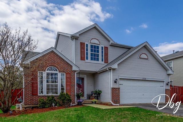 254 Spring Valley Way, Round Lake, IL 60073 - traditional-style home with a front lawn, fence, brick siding, an attached garage, and aphalt driveway