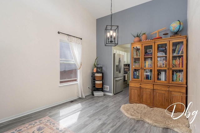 254 Spring Valley Way, Round Lake, IL 60073 - dining area featuring visible vents, light wood-type flooring, baseboards, high vaulted ceiling, and a notable chandelier