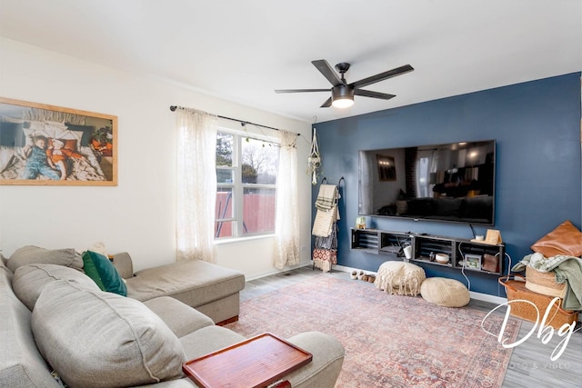 254 Spring Valley Way, Round Lake, IL 60073 - living area featuring wood finished floors, a ceiling fan, and baseboards