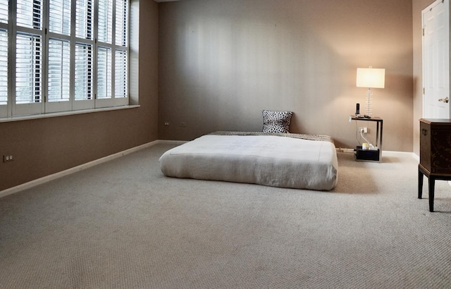 bedroom featuring carpet flooring and baseboards